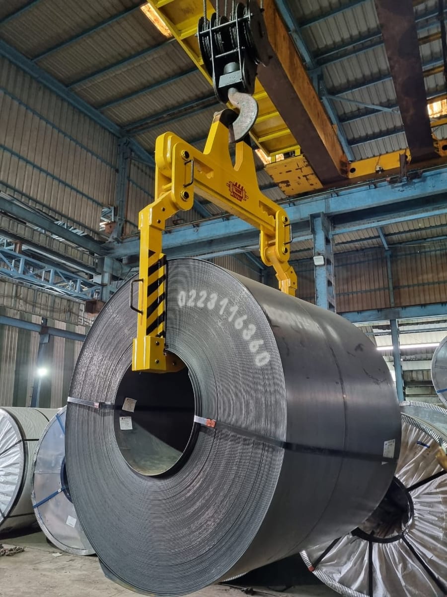 Manual coil tong gripping a steel coil by its outer diameter β Pragya Precision Equipment