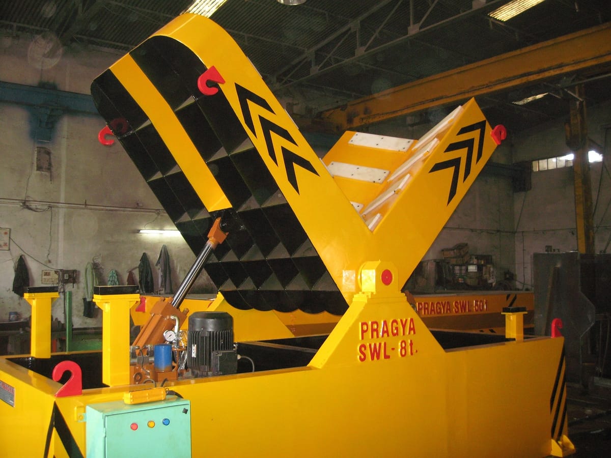 Hydraulic coil tilter mid-rotation — smooth, controllable movement across the 0-90 degree range