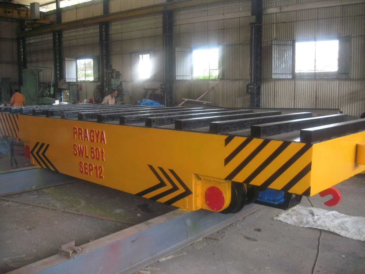 A rail-mounted transfer trolley of the kind offered with battery, cable reel or busbar power