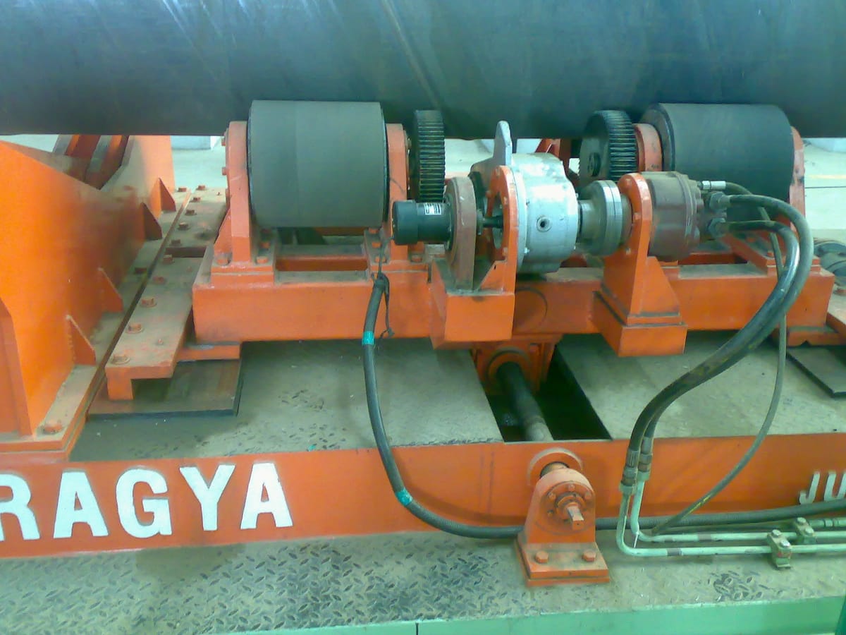 Pipe rotator showing the motorized rollers and height adjustment mechanism